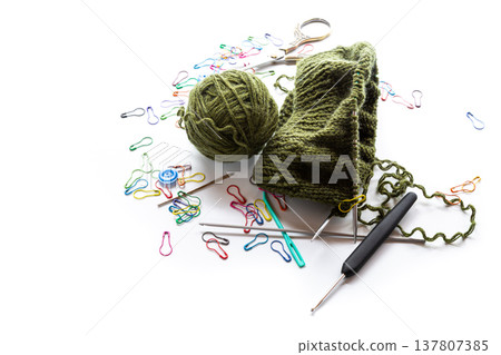 handmade knitting project with wool yarn and knitting tools 137807385