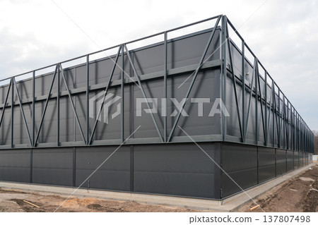 Modern Industrial Warehouse Exterior with Steel Frame Structure and Dark Metal Facade Panels Modern Industrial Warehouse Exterior with Steel Frame Structure and Dark Metal Facade Panels 137807498