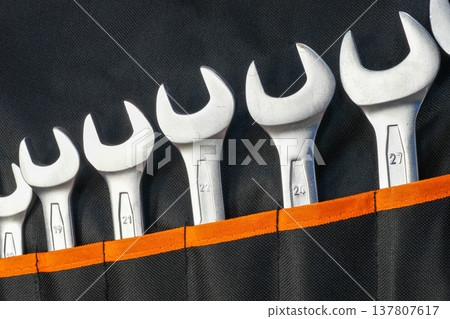 Set of Open-End Wrenches in Tool Roll Organizer Close-Up with Various Sizes for Mechanical Work 137807617