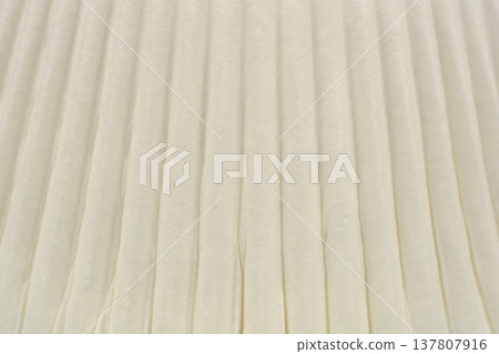 Close up texture of a white pleated paper cupcake liner Close up texture of a white pleated paper cupcake liner 137807916
