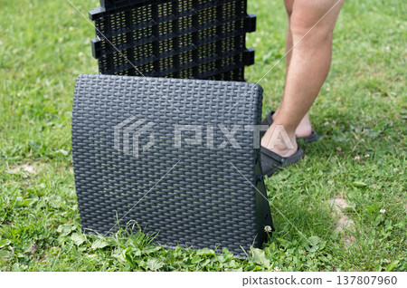Folding patio furniture on grass. Easy outdoor setup. Folding patio furniture on grass. Easy outdoor setup. 137807960