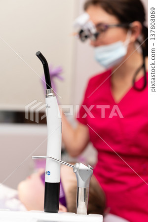 Dental professional assists young patient in a bright clinic, focusing on oral care techniques while ensuring comfort and safety during the procedure Dental professional assists young patient in a bright clinic, focusing on oral care techniques while ensuring comfort and safety during the procedure 137808069