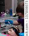 Smiles illuminated as a dedicated dentist provides care in a modern clinic during an afternoon appointment filled with laughter and anticipation of bright results 137808073