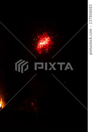 Celebration lights up the night sky with vibrant fireworks illuminating urban landscapes during a festive evening in late summer 137808083