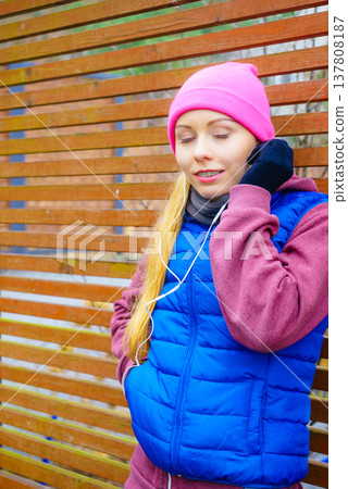 Woman wearing warm sportswear relaxing after exercising 137808187