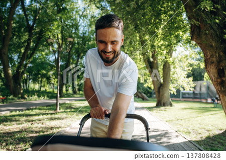 Very happy, parenting conception. Father is with cradle, having a walk in the park 137808428