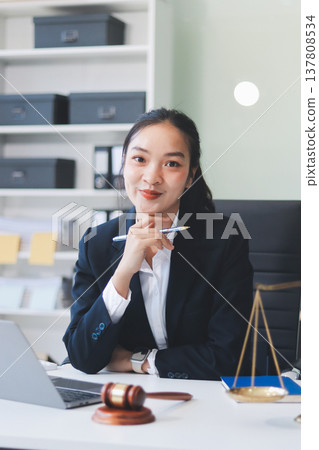 Lawyer explained to the client about the law that must be brought against the court case. Lawyer explained to the client about the law that must be brought against the court case. 137808534