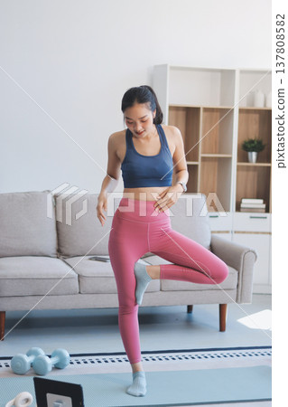 Young Asian sporty attractive people practicing yoga lesson with instructor. Asia group of women exercising healthy lifestyle in fitness studio. Sport activity, gymnastics or ballet dancing class. Young Asian sporty attractive people practicing yoga lesson with instructor. Asia group of women exercising healthy lifestyle in fitness studio. Sport activity, gymnastics or ballet dancing class. 137808582