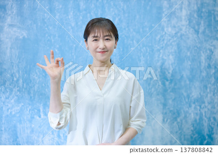 A woman in her 60s smiling and looking at the camera. A woman in her 60s smiling and looking at the camera. 137808842
