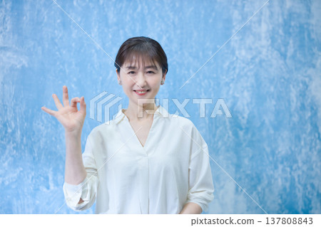 A woman in her 60s smiling and looking at the camera. A woman in her 60s smiling and looking at the camera. 137808843