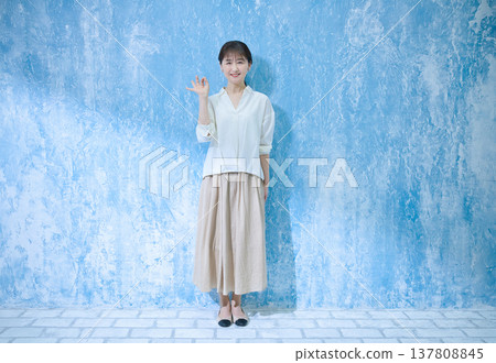 A woman in her 60s smiling and looking at the camera. 137808845