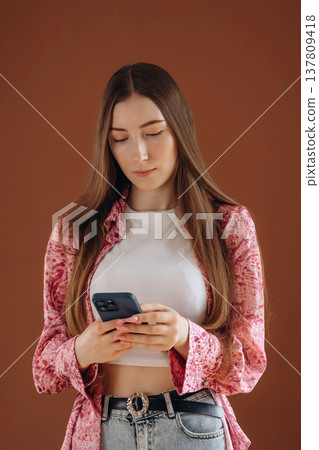 Woman in casual clothes is against background Woman in casual clothes is against background 137809418