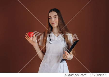Little red heart, cardiologist. Female doctor is in the studio Little red heart, cardiologist. Female doctor is in the studio 137809443