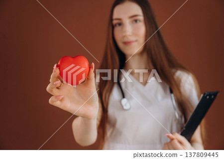Little red heart, cardiologist. Female doctor is in the studio 137809445