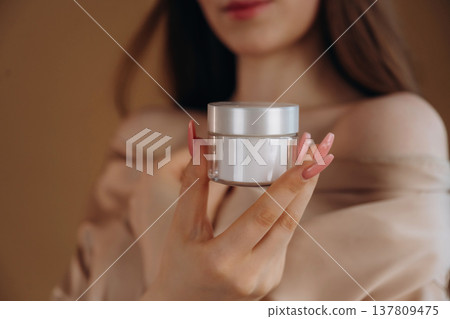 Showing the product. Close up view of woman that is with cream for skin 137809475