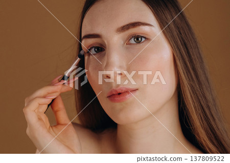 Make up, cosmetics conception. Young woman is against background 137809522