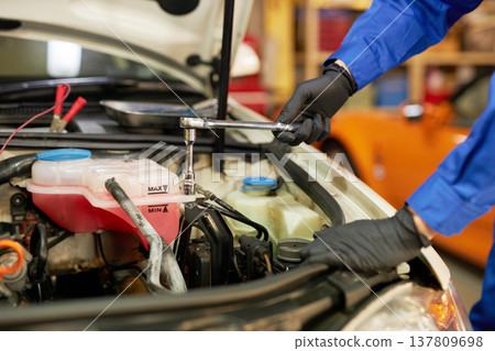 Auto mechanic repairing under the hood Auto mechanic repairing under the hood 137809698
