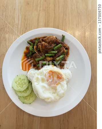 Spicy pork stir fry fried egg white rice cucumber slice thai food asian cuisine street food lunch dinner comfort food homemade savory chili sauce green bean cooked meat protein side dish vegetable Spicy pork stir fry fried egg white rice cucumber slice thai food asian cuisine street food lunch dinner comfort food homemade savory chili sauce green bean cooked meat protein side dish vegetable 137809750