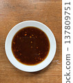 Brown sauce spicy sauce chili sauce dipping sauce asian sauce hot sauce savory sauce condiment small bowl wooden table Brown sauce spicy sauce chili sauce dipping sauce asian sauce hot sauce 137809751