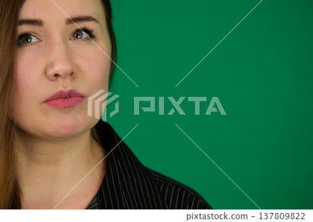 Different emotions of a woman's pose in black on a green background 137809822