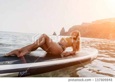 Woman Paddleboard Ocean Relaxing on Paddleboard in the Sea while Relaxing 137809848