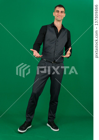 Various emotions and movements of a man in a gray suit on a green background in a vest and pants, many different poses Various emotions and movements of a man in a gray suit on a green background in a vest and pants, many different poses 137809866