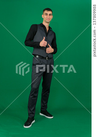 Various emotions and movements of a man in a gray suit on a green background in a vest and pants, many different poses Various emotions and movements of a man in a gray suit on a green background in a vest and pants, many different poses 137809988