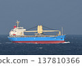 A cargo ship sailing on a cloudy sea. 137810366