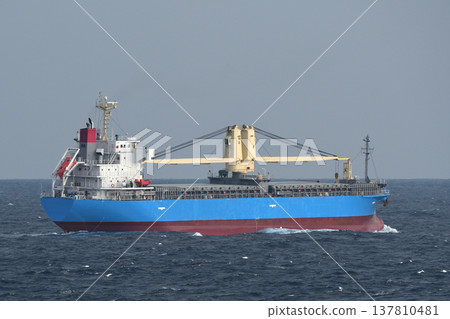 A cargo ship sailing on a cloudy sea. A cargo ship sailing on a cloudy sea. 137810481