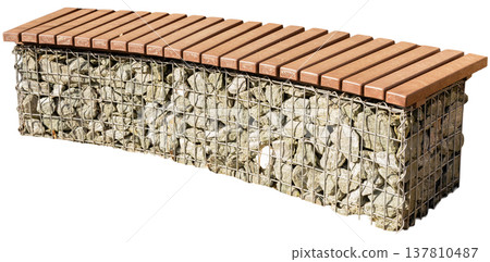 This bench features a stone base held together by wire, topped with wood slats for sitting. It is ideal for outdoor areas like parks or gardens, designed for relaxation This bench features a stone base held together by wire, topped with wood slats for sitting. It is ideal for outdoor areas like parks or gardens, designed for relaxation 137810487