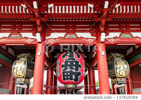 Building view of the Hozomon of Kinryu-zan Senso-ji in Asakusa, Tokyo, Japan. The gate hung with three large lanterns displayed the Nio statues on both sides. 137810569