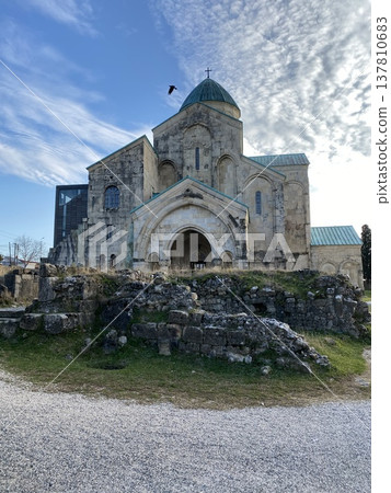 Ancient cathedral with stone ruins and cloudy sky in background, bird in flight, historical site Ancient cathedral with stone ruins and cloudy sky in background, bird in flight, historical site 137810683