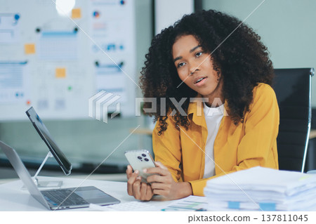 Pretty female freelancer working on laptop while sitting on modern coworking background Pretty female freelancer working on laptop while sitting on modern coworking background 137811045