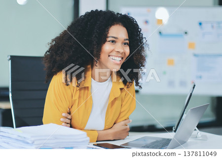Pretty female freelancer working on laptop while sitting on modern coworking background Pretty female freelancer working on laptop while sitting on modern coworking background 137811049