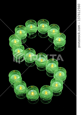 The letter S on a green candle The letter S on a green candle 137812560