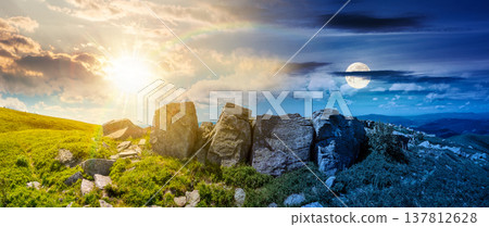 mountainous panorama with huge stones near hillside. day meet night. beautiful summer solstice landscape on a cloudy weather. sun and moon over alpine scenery with green grassy meadow. epic outdoors 137812628