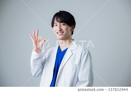 A young man wearing a white suit A young man wearing a white suit 137812944
