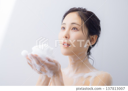 A woman washing her face A woman washing her face 137813007