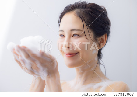 A woman washing her face A woman washing her face 137813008