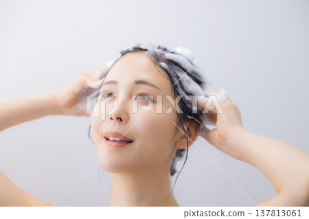 A woman shampooing A woman shampooing 137813061