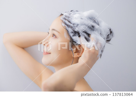 A woman shampooing A woman shampooing 137813064