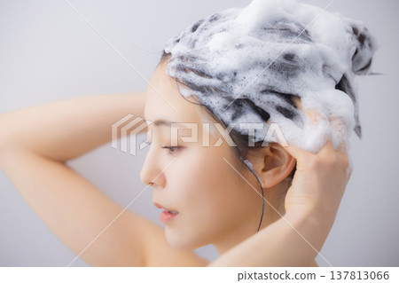 A woman shampooing A woman shampooing 137813066