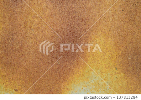 A horizontal close-up shot of a heavily oxidized metal surface, featuring a dense and uniform texture of orange and brown rust. 137813284