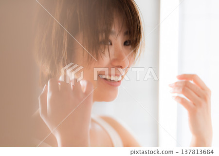 A woman smiling in bright light A woman smiling in bright light 137813684