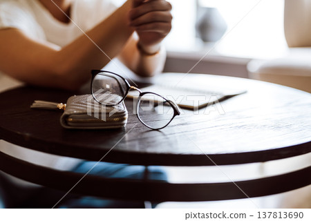 Glasses and wallet on the table Glasses and wallet on the table 137813690