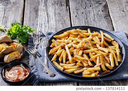 crispy french fries on a plate with dipping sauce 137814111