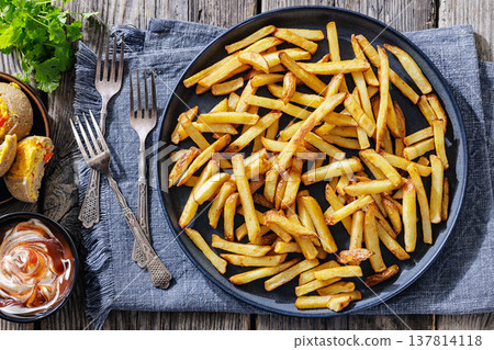 Crispy french fries on a plate with dipping sauce 137814118