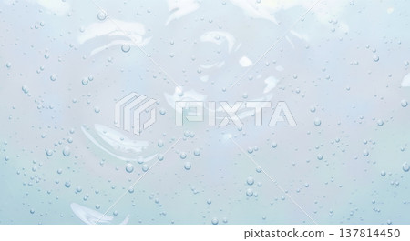 Abstract background texture of clear liquid gel with bubbles and smears on light blue surface representing moisturizing cosmetic product or medical sanitizer Abstract background texture of clear liquid gel with bubbles and smears on light blue surface representing moisturizing cosmetic product or medical sanitizer 137814450