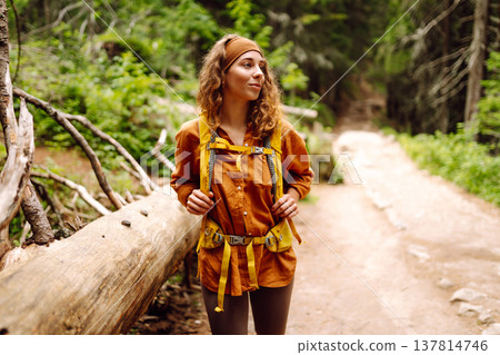 Young woman with backpack traveling outdoors. Hiking, active lifestyle. 137814746