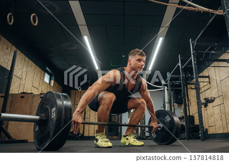 No pain, no gain, weightlifting. Athletic man is with a barbell in a gym 137814818